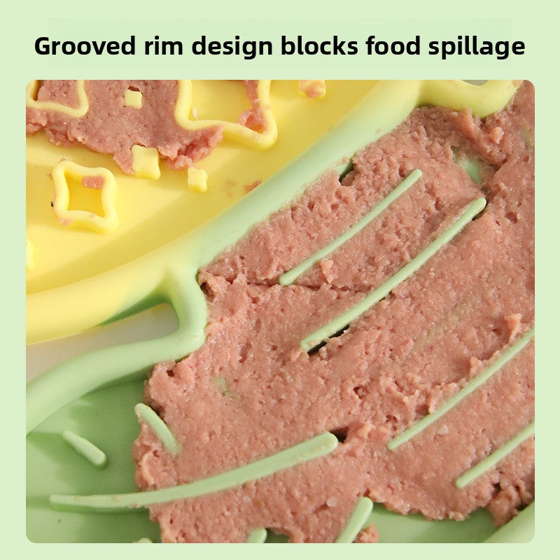 Silicone mold with pink silicone food product and green grooved rim design on a light green background.